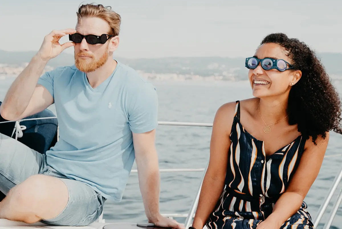 Un homme et une femme portent des lunettes Boarding Glasses en bateau pour éviter le mal de mer